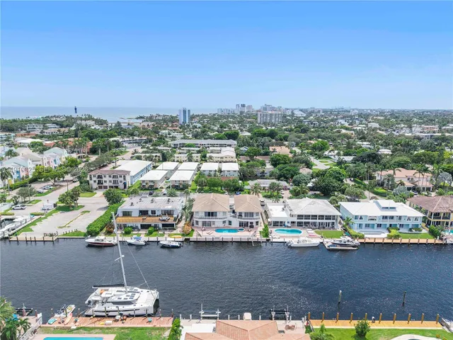 a view of a kitchen with a sink and an empty room