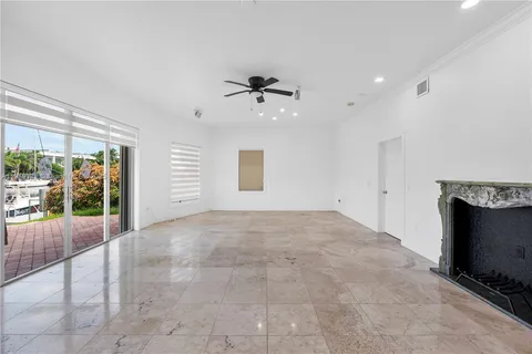 a view of a kitchen with a sink and an empty room