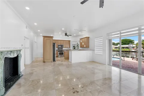 an empty room with furniture and a kitchen