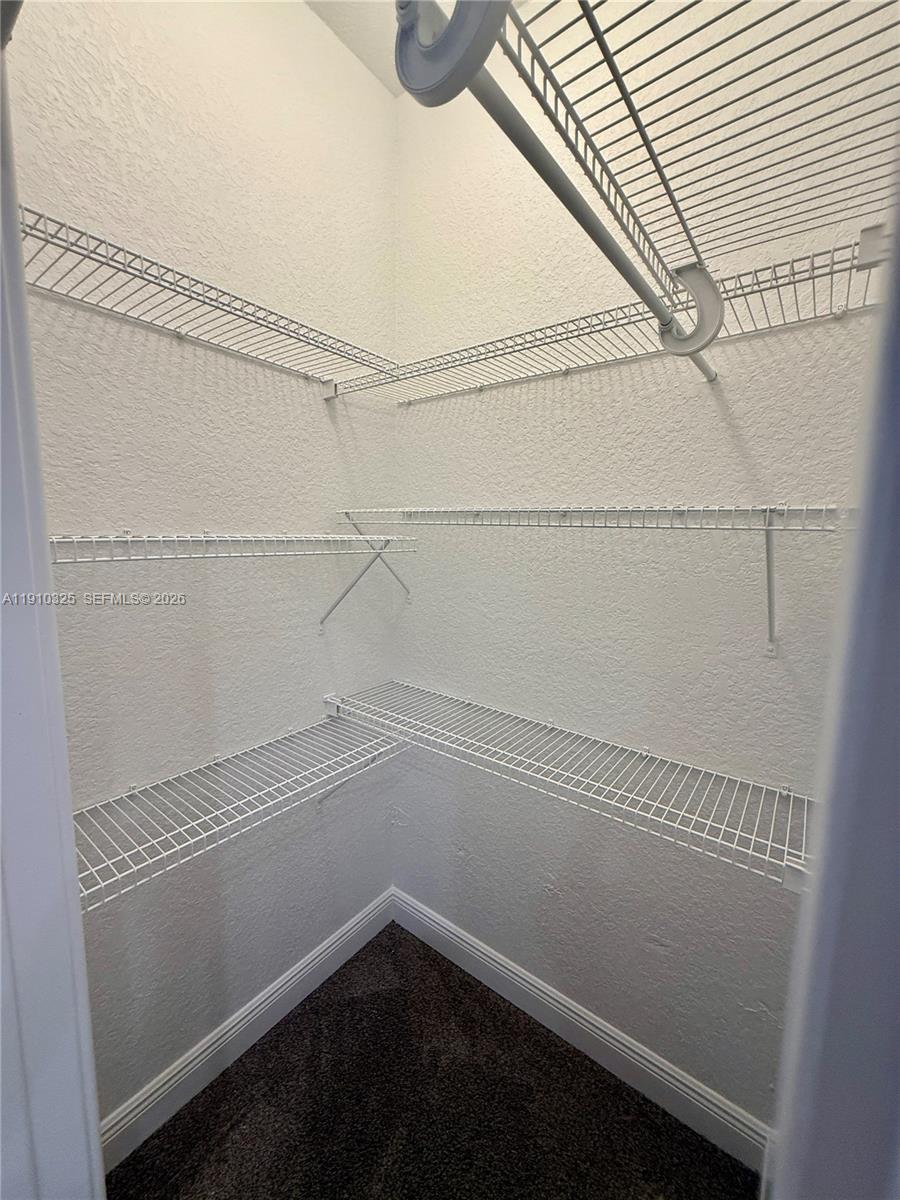 2737 Northeast 28th Court, Unit 1 Lighthouse Point, FL 33064 - Photo 41 of 46 a view of a room with racks on the wall