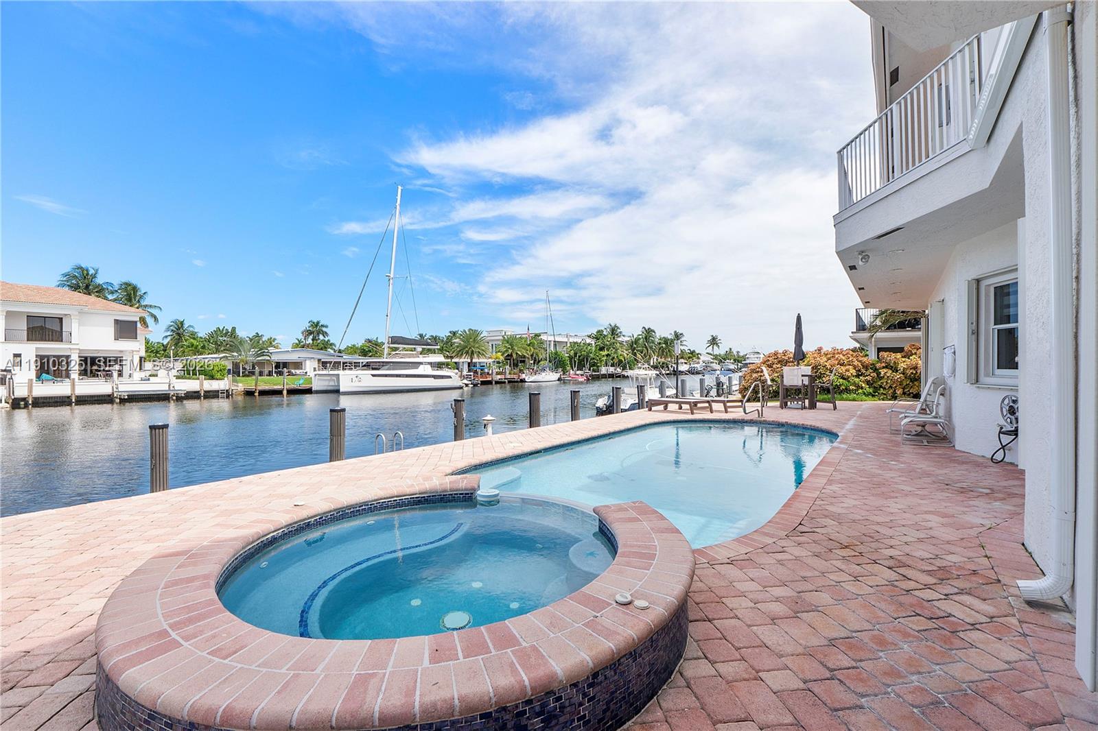 2737 Northeast 28th Court, Unit 1 Lighthouse Point, FL 33064 - Photo 7 of 46 a view of a swimming pool with a lounge chair