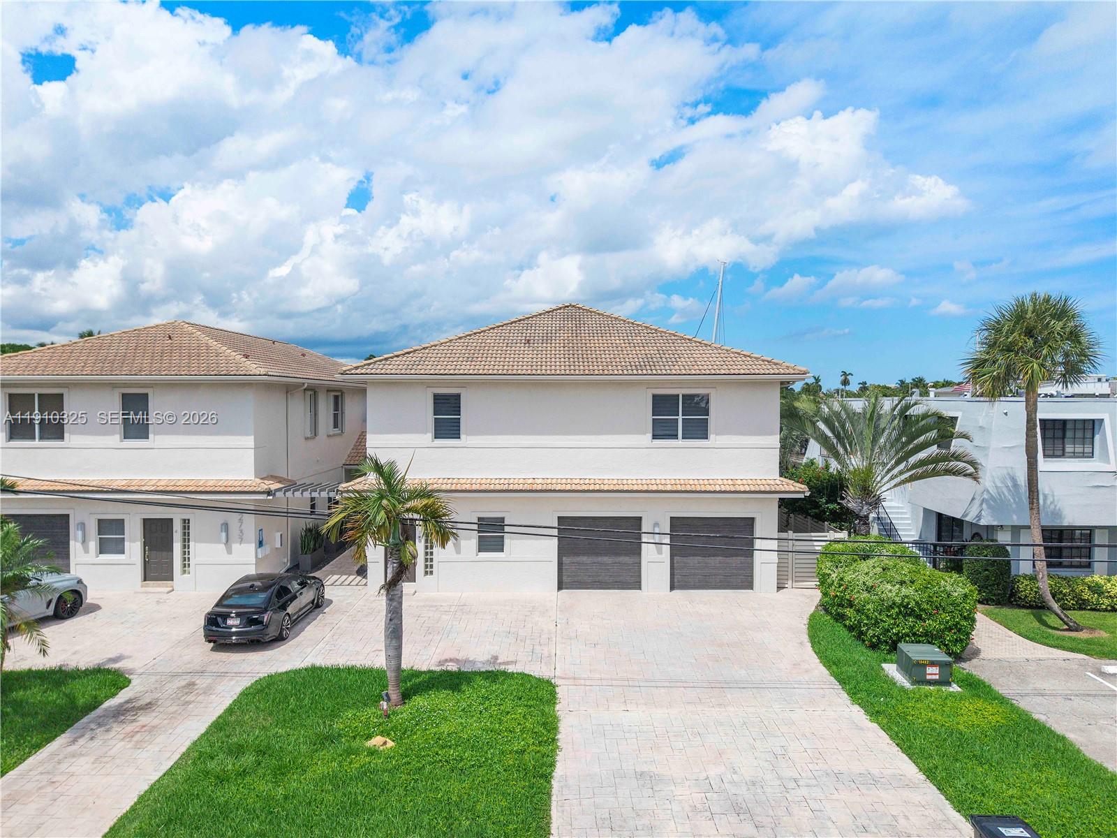 2737 Northeast 28th Court, Unit 1 Lighthouse Point, FL 33064 - Photo 10 of 46 a front view of house with yard and green space