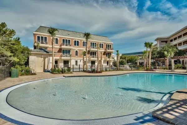 a view of a swimming pool with outdoor seating