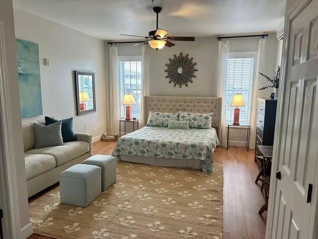 a bedroom with a bed couch and window