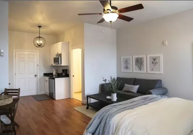 a bedroom with bed furniture and a window