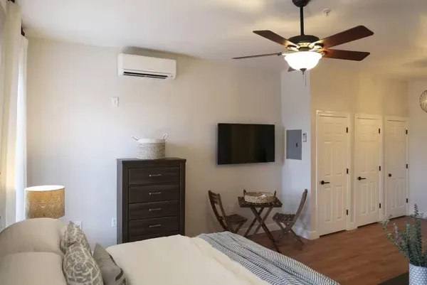 a bedroom with a bed and a flat screen tv