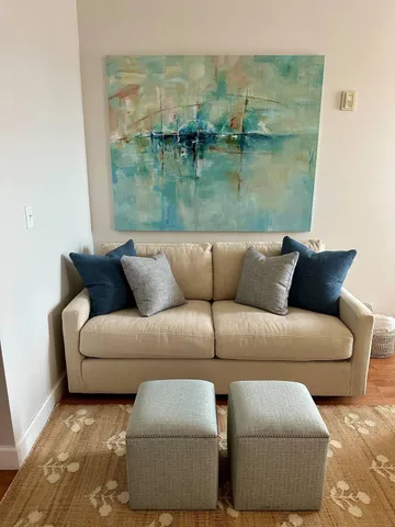 a living room with furniture and a floor to ceiling window