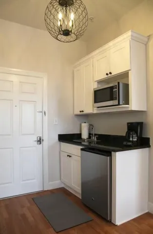 a kitchen with stainless steel appliances a stove a microwave and cabinets