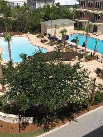 a view of swimming pool with a yard and lake view