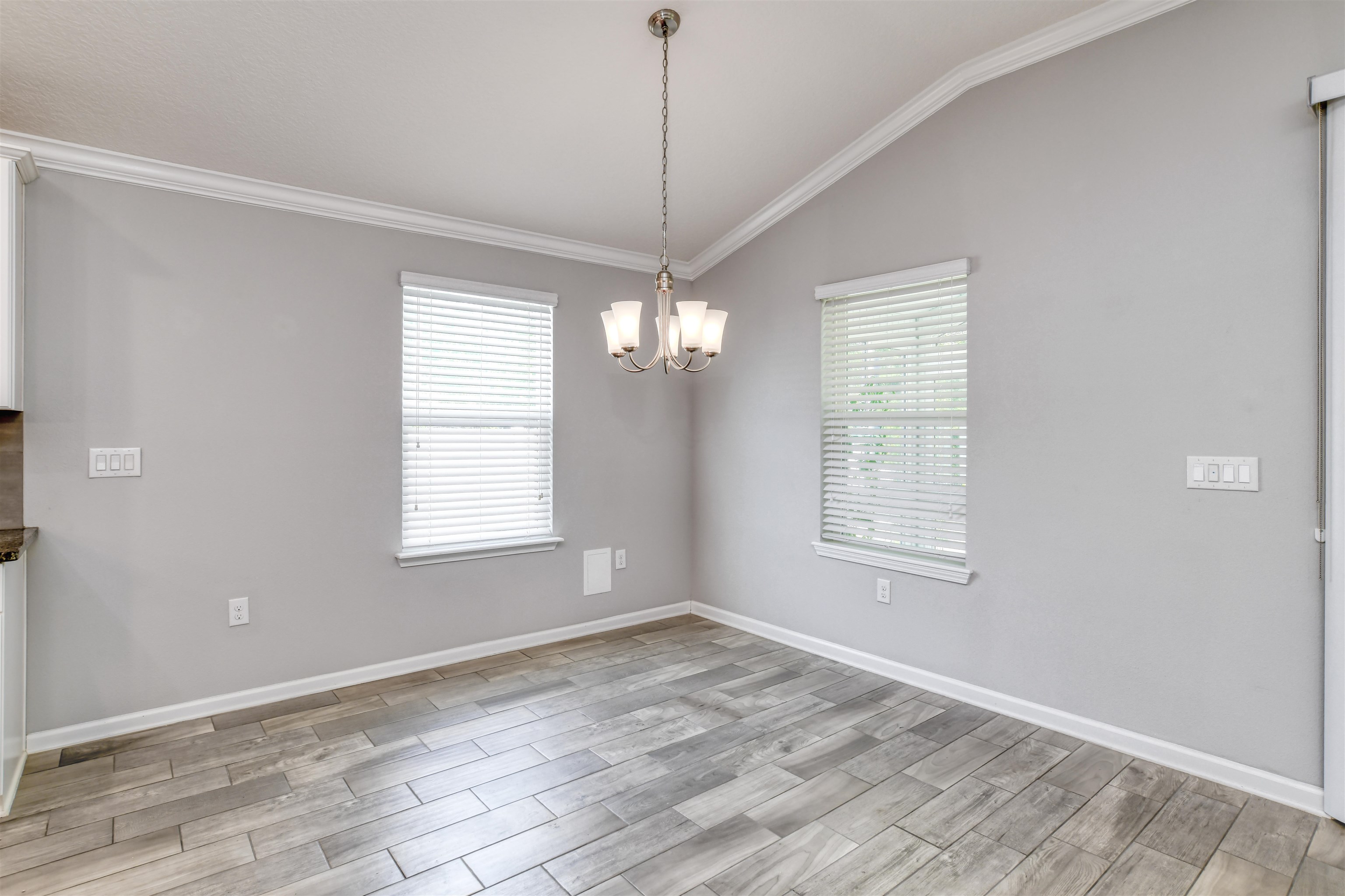 485 Crescent Key Drive St. Augustine, FL 32086 - Photo 11 of 46 a view of empty room with wooden floor and fan