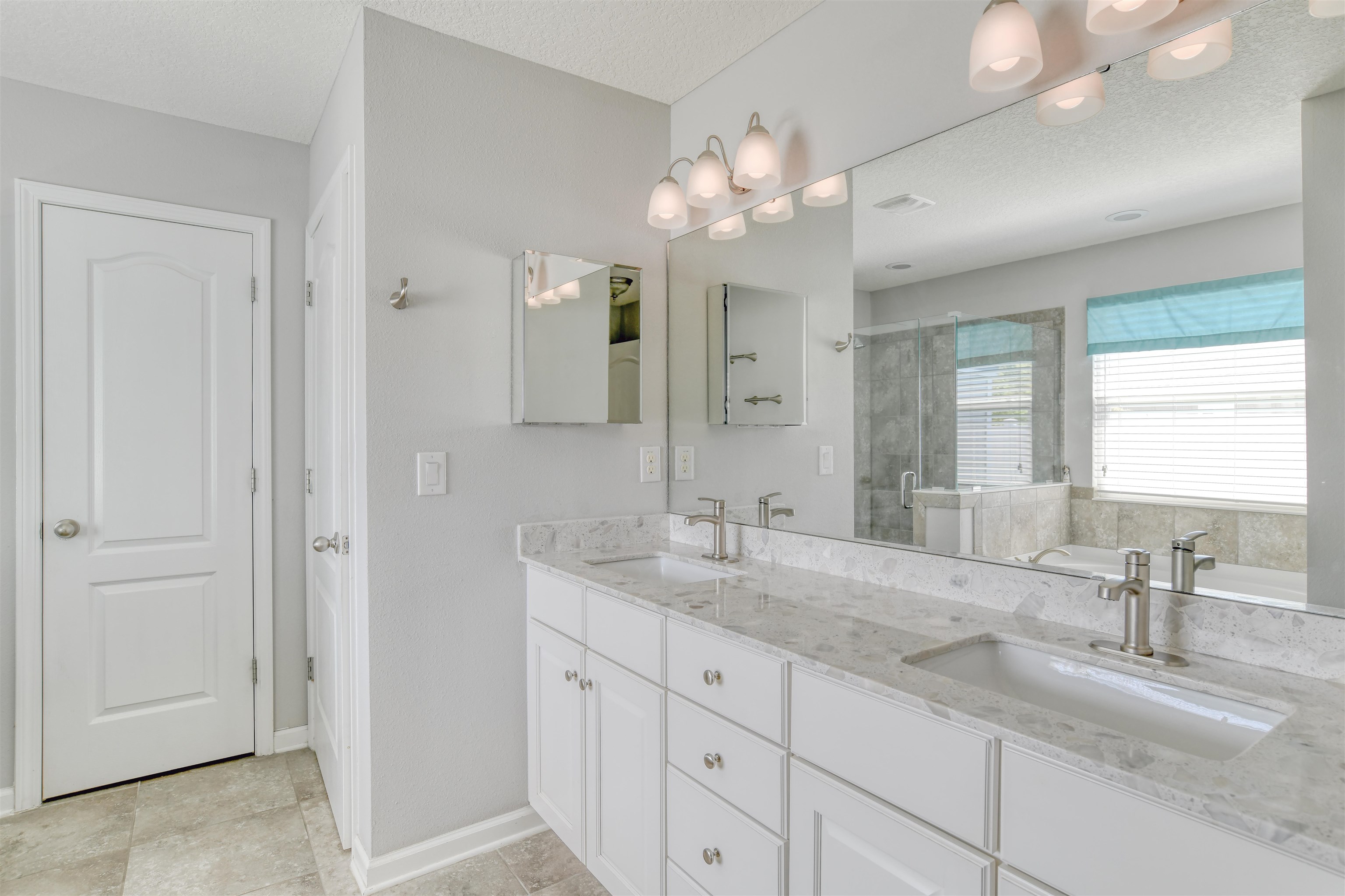 485 Crescent Key Drive St. Augustine, FL 32086 - Photo 27 of 46 a bathroom with a sink double vanity and a mirror