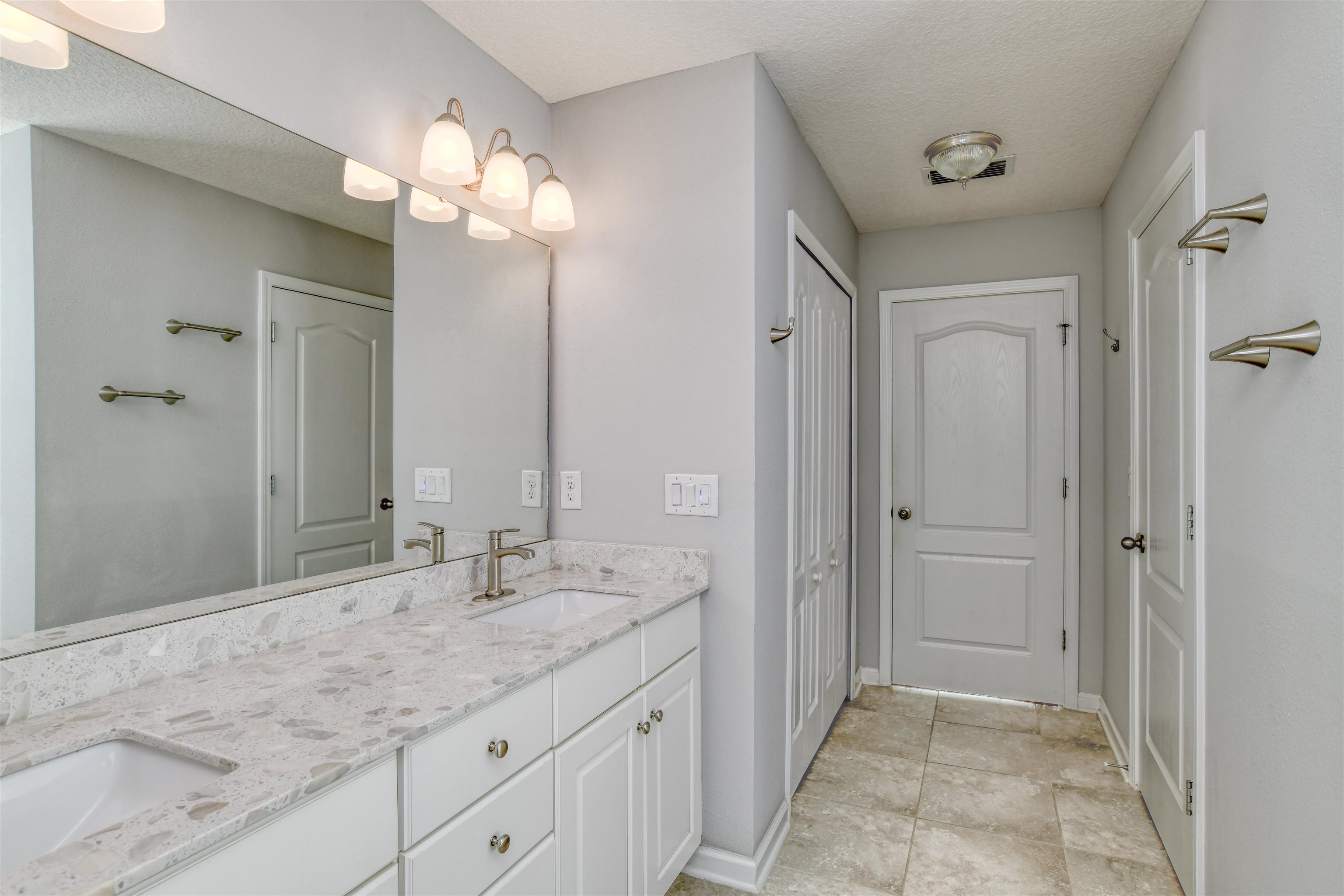 485 Crescent Key Drive St. Augustine, FL 32086 - Photo 31 of 46 a bathroom with a granite countertop sink a mirror and a shower