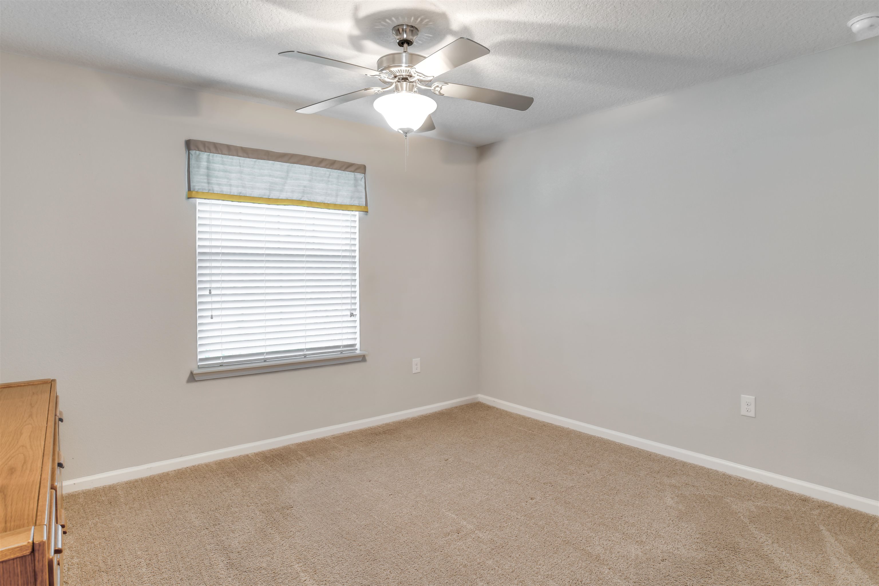 485 Crescent Key Drive St. Augustine, FL 32086 - Photo 32 of 46 an empty room with a window and a fan