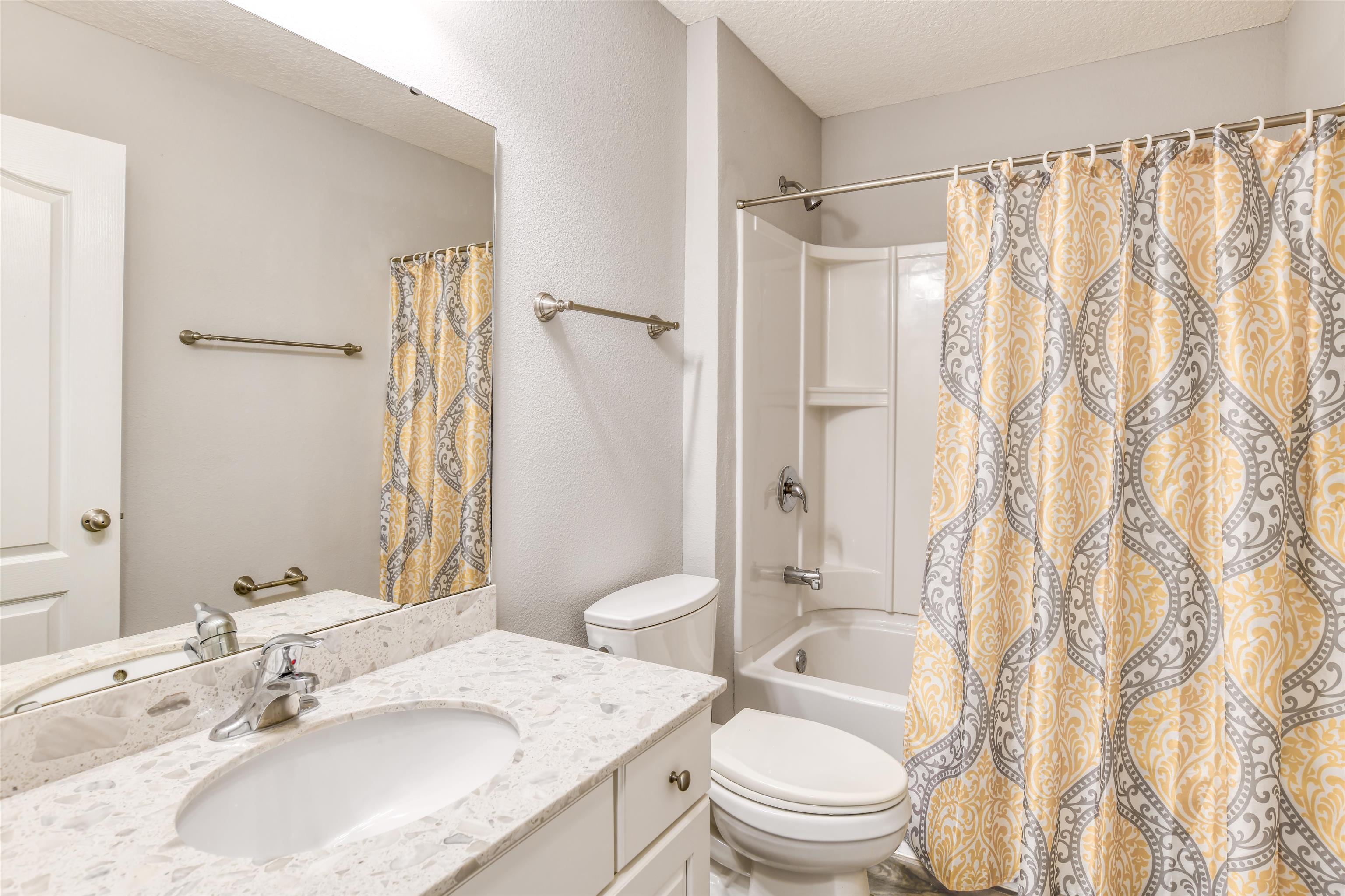485 Crescent Key Drive St. Augustine, FL 32086 - Photo 34 of 46 a bathroom with a granite countertop sink toilet and shower