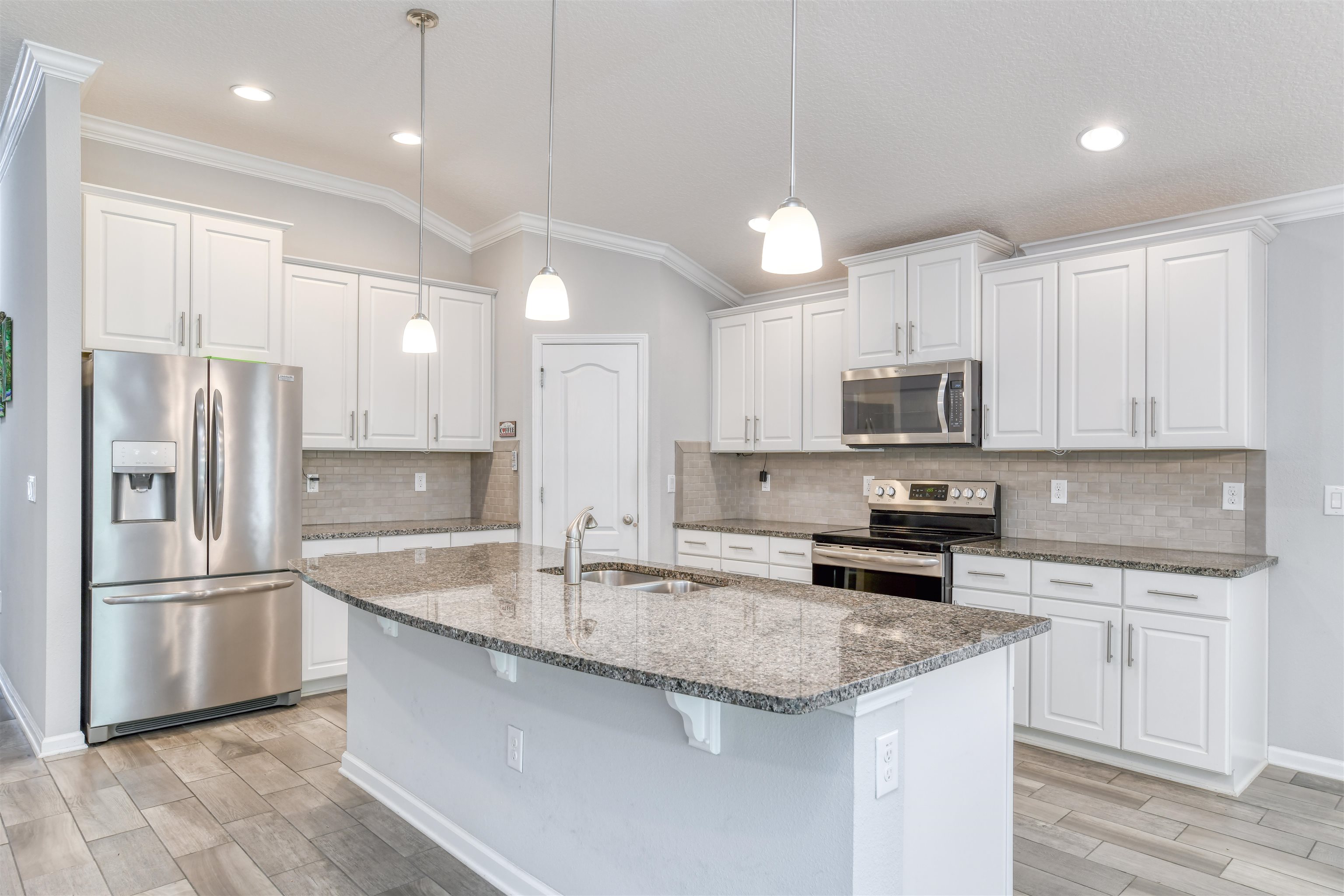 485 Crescent Key Drive St. Augustine, FL 32086 - Photo 8 of 46 a kitchen with stainless steel appliances granite countertop a sink stove and refrigerator