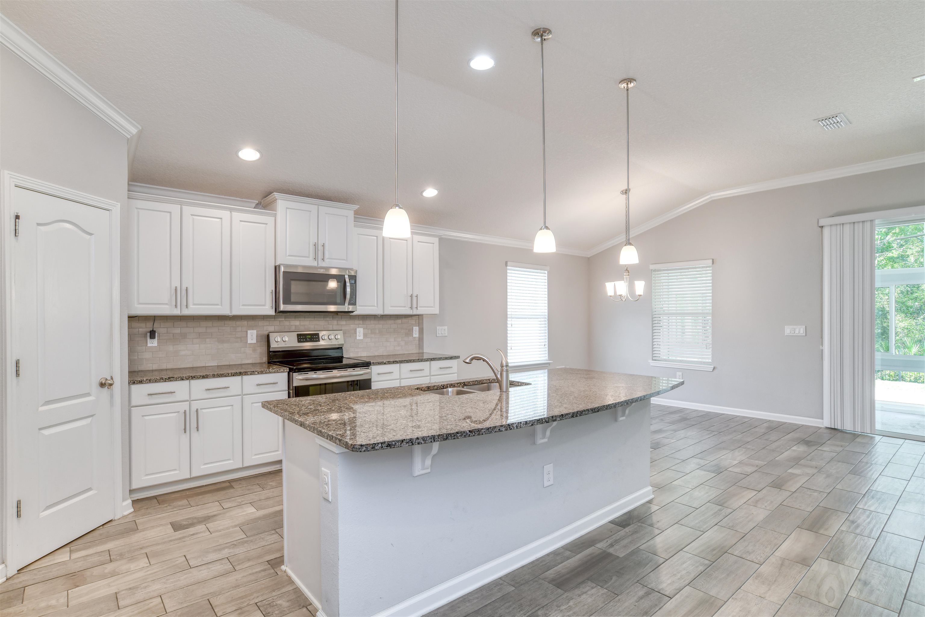 485 Crescent Key Drive St. Augustine, FL 32086 - Photo 9 of 46 a kitchen with kitchen island a sink stainless steel appliances and cabinets