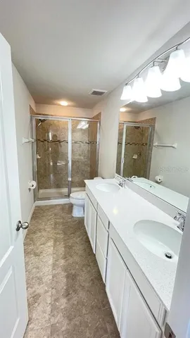 a bathroom with a double vanity sink and mirror