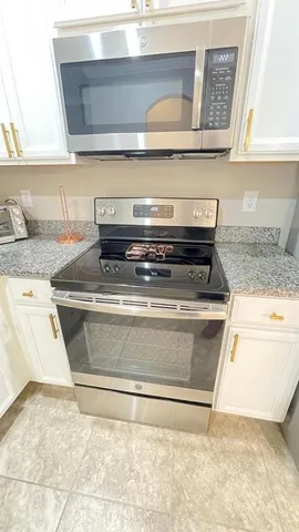 a stove top oven sitting inside of a kitchen