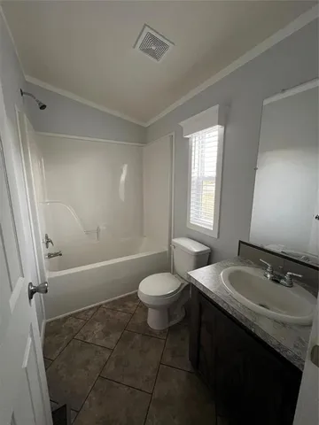 a bathroom with a granite countertop sink toilet a mirror and shower