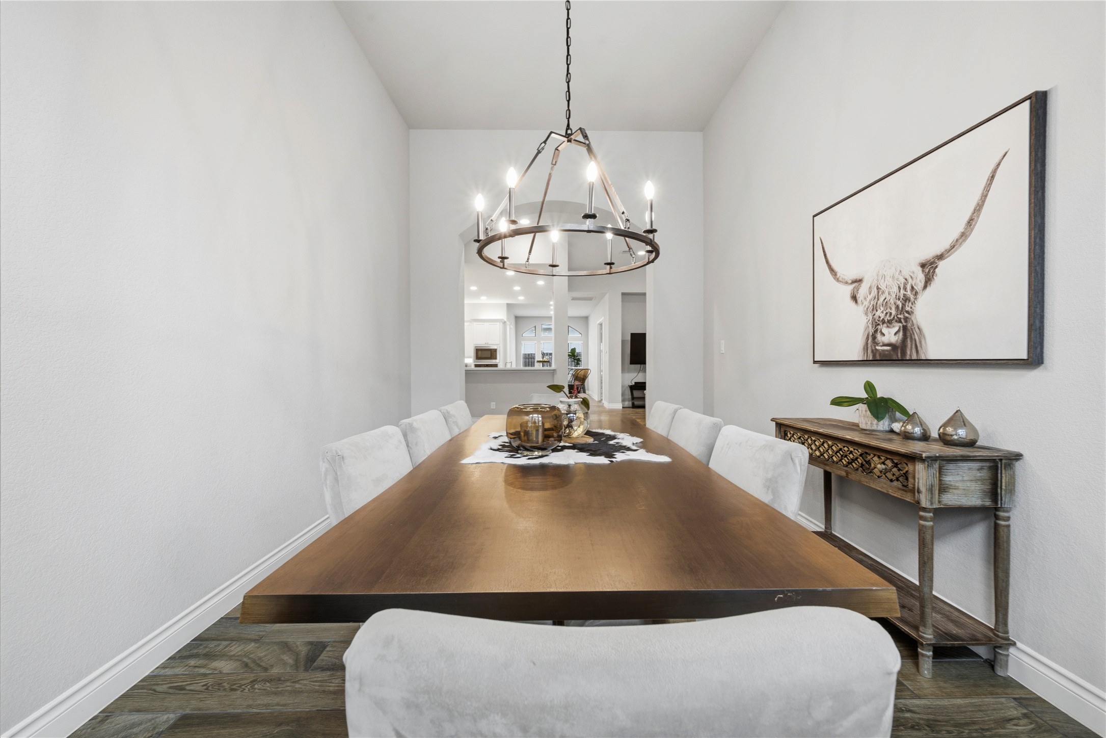 140 Catani Loop Georgetown, TX 78628 - Photo 20 of 36 A spacious dining room features elegant flooring and a statement chandelier, perfect for memorable gatherings.