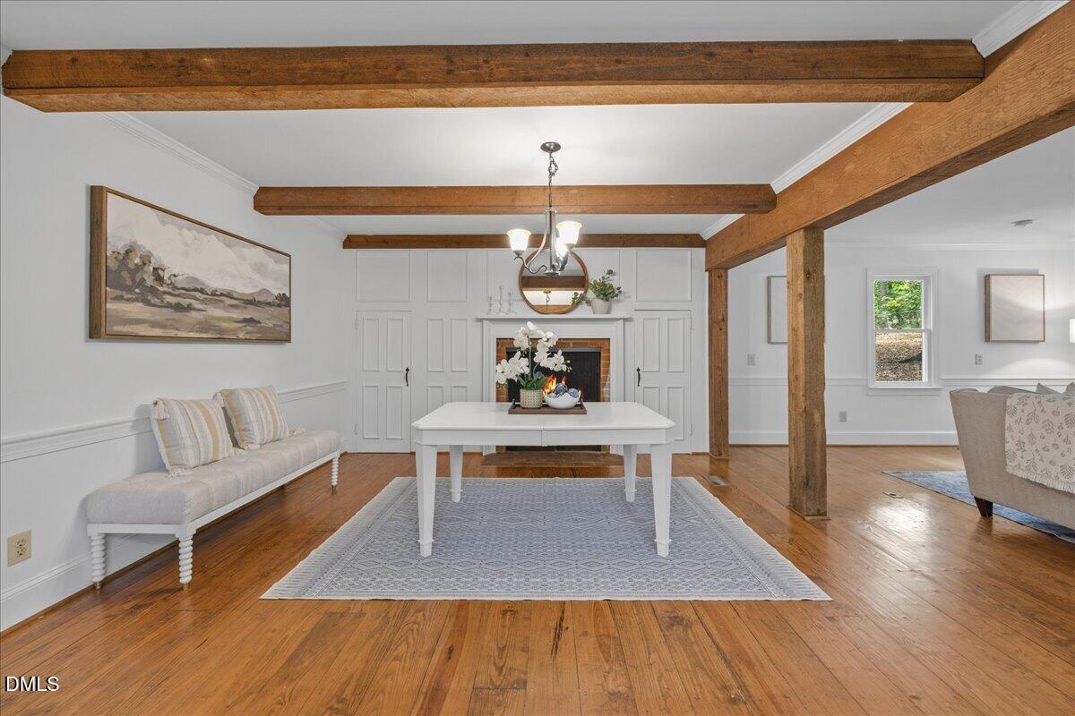 6516 Bakersfield Drive Raleigh, NC 27606 - Photo 16 of 59 a living room with furniture and a wooden floor