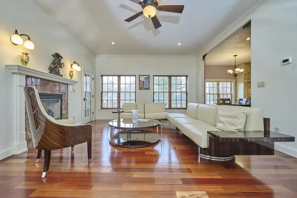 a living room with fireplace furniture and a wooden floor
