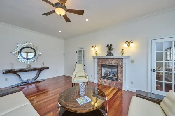 a living room with furniture a fireplace and a chandelier