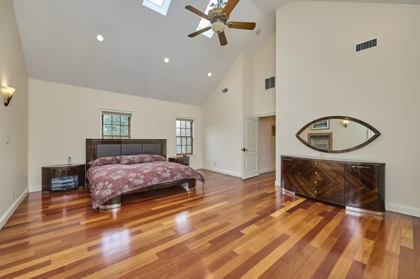 a bedroom with a bed and wooden floor