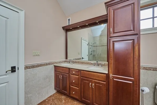 a bathroom with a granite countertop sink mirror and double