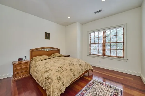 a bed sitting in a bedroom next to a window