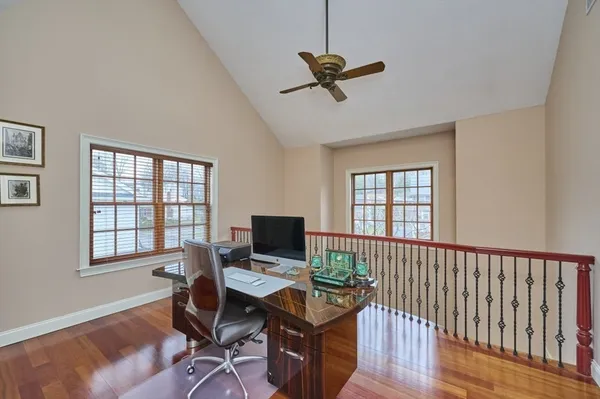 a view of a workspace with furniture and a window