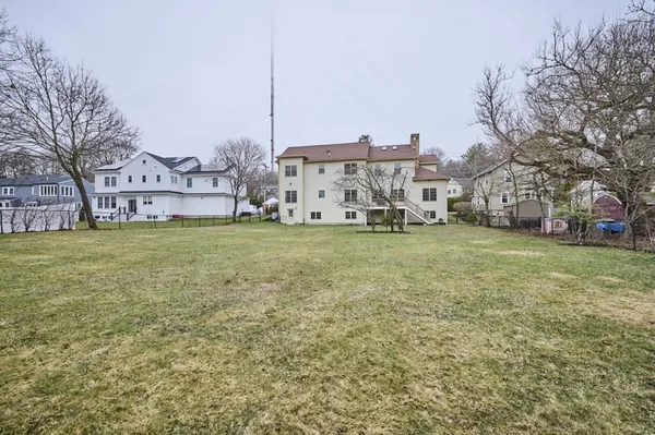 a view of a city with tall buildings and a big yard