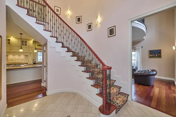 a view of entryway and hall with wooden floor