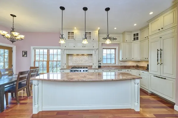 a kitchen with kitchen island granite countertop lots of counter top space and stainless steel appliances