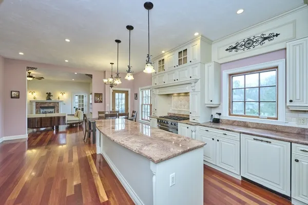 a kitchen with stainless steel appliances granite countertop sink stove top oven and cabinets