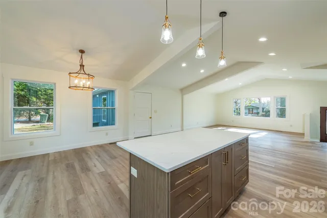 a kitchen with a stove and a wooden floors
