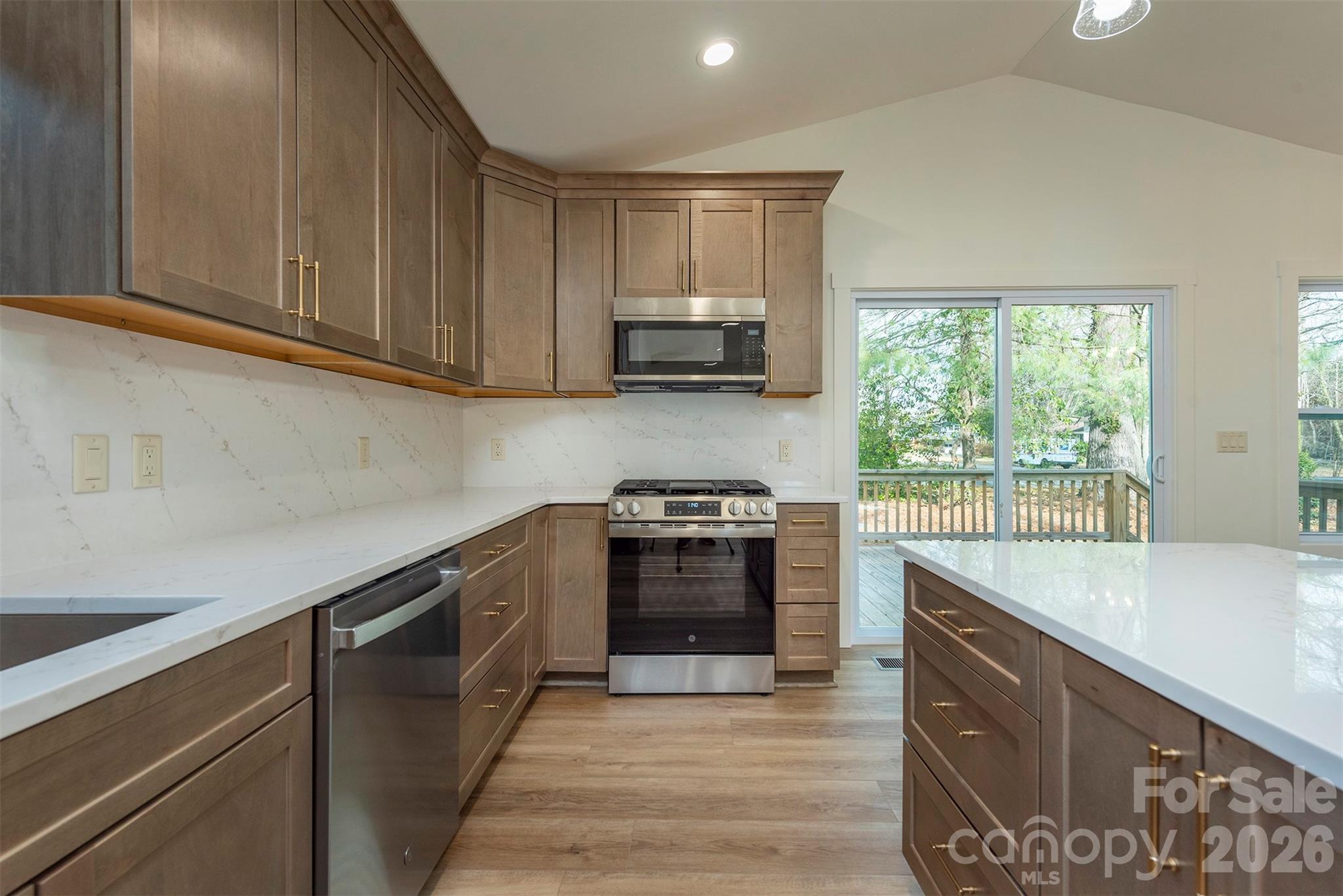 524 Pineland Road Hendersonville, NC 28792 - Photo 13 of 36 a kitchen with stainless steel appliances granite countertop a sink and a stove