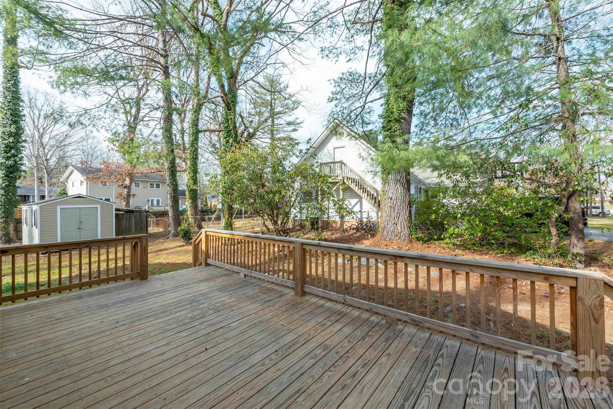 524 Pineland Road Hendersonville, NC 28792 - Photo 16 of 36 a view of a wooden deck with trees