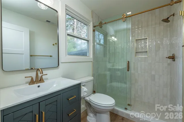 a bathroom with a sink toilet and shower
