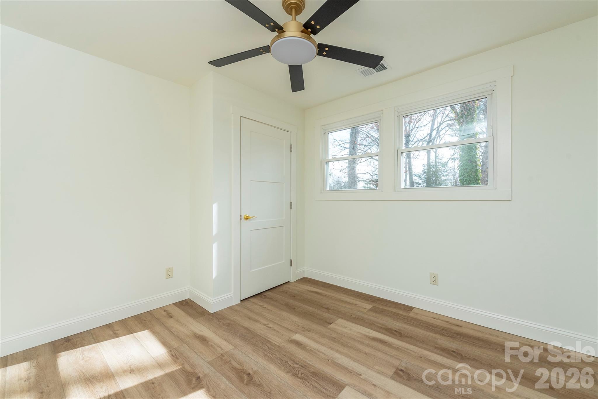 524 Pineland Road Hendersonville, NC 28792 - Photo 24 of 36 an empty room with a window and a ceiling fan