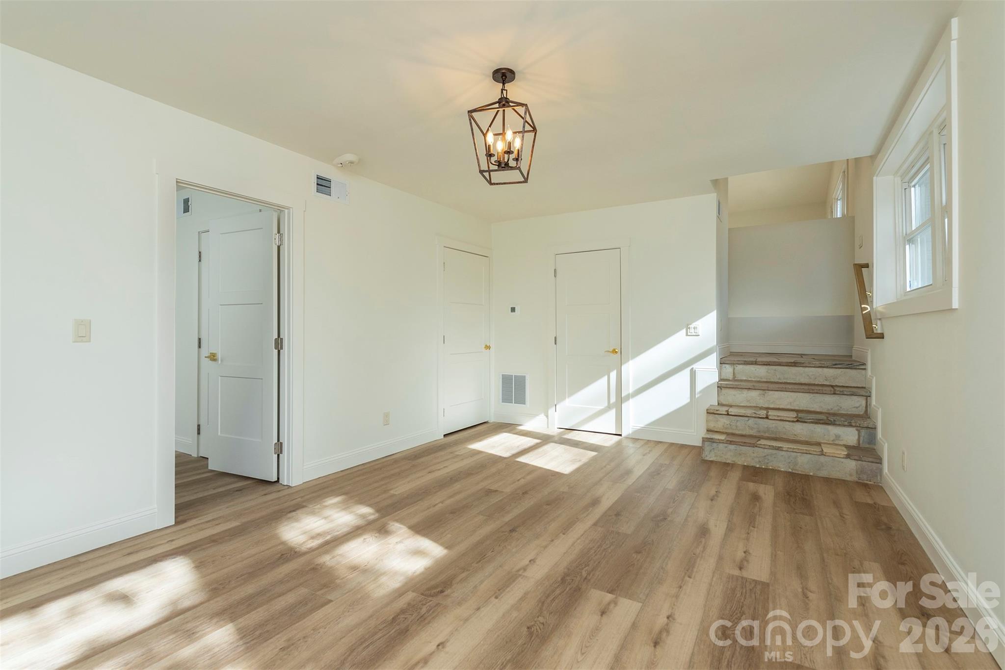 524 Pineland Road Hendersonville, NC 28792 - Photo 27 of 36 a view of empty room with wooden floor and window