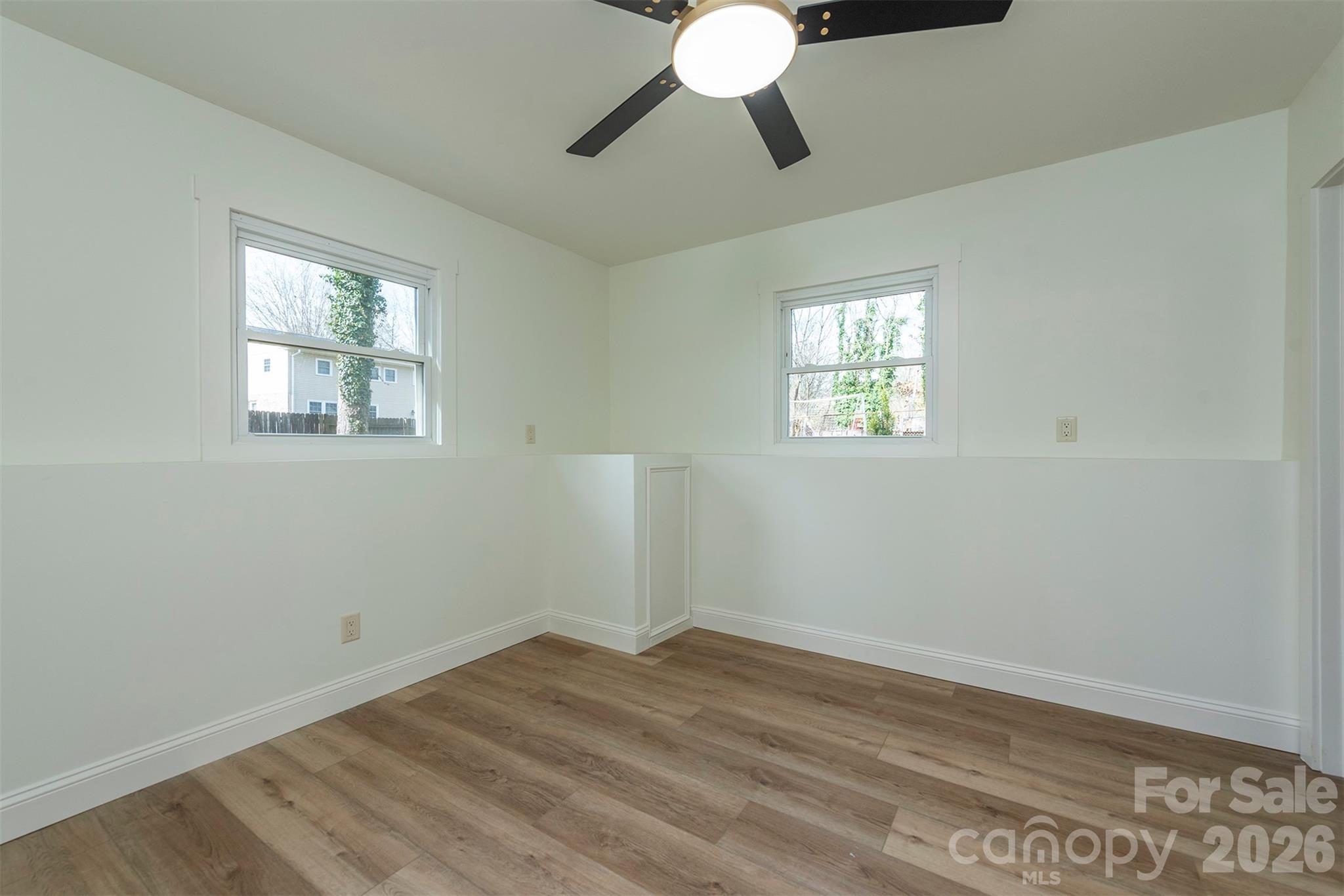 524 Pineland Road Hendersonville, NC 28792 - Photo 28 of 36 a view of empty room with wooden floor and fan