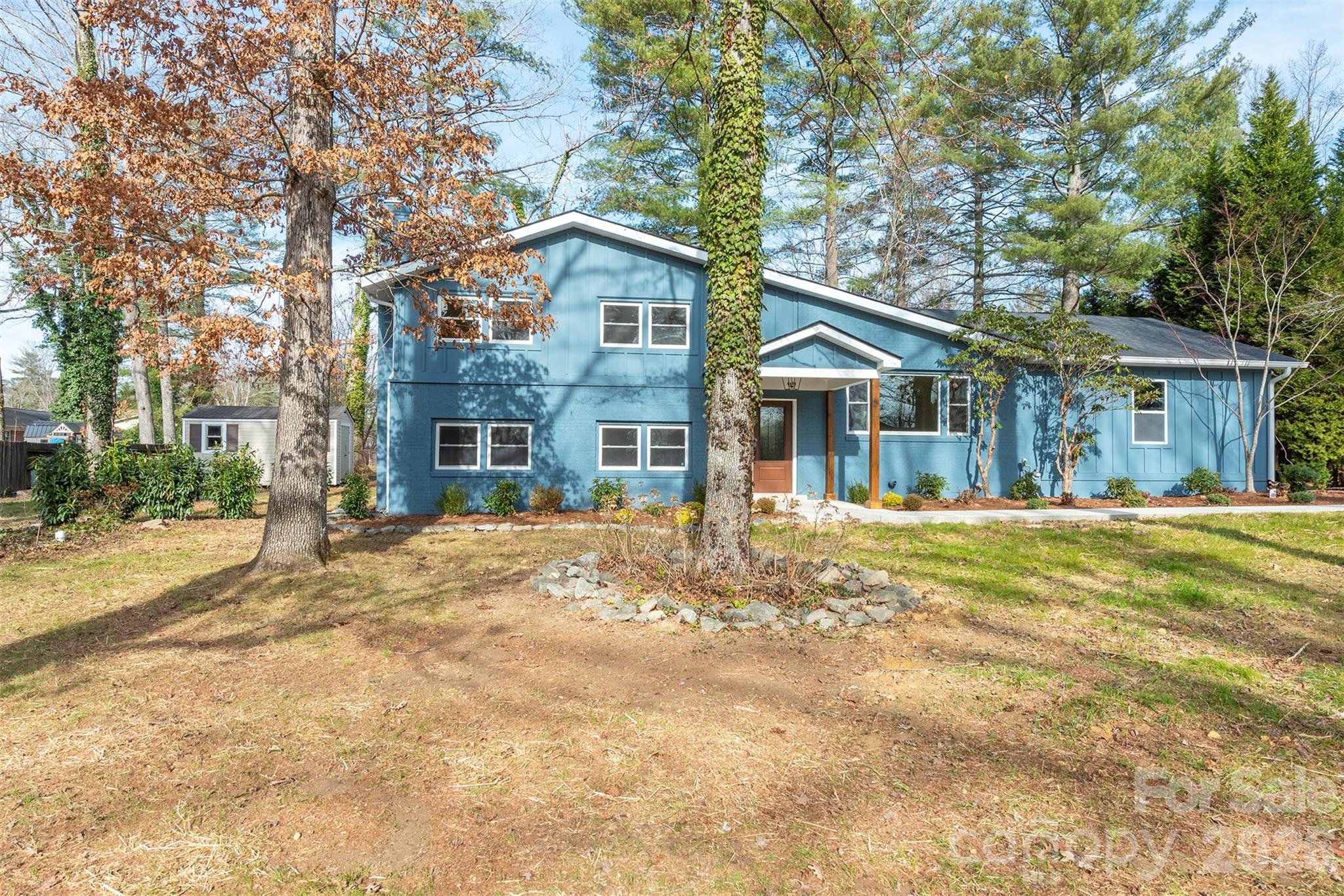 524 Pineland Road Hendersonville, NC 28792 - Photo 3 of 36 a front view of a house with a tree in front