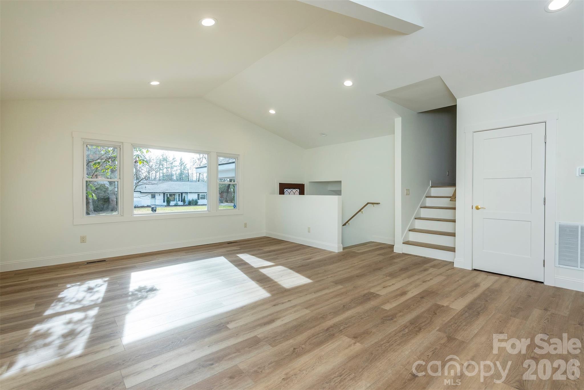 524 Pineland Road Hendersonville, NC 28792 - Photo 6 of 36 a view of a bedroom with wooden floor and window