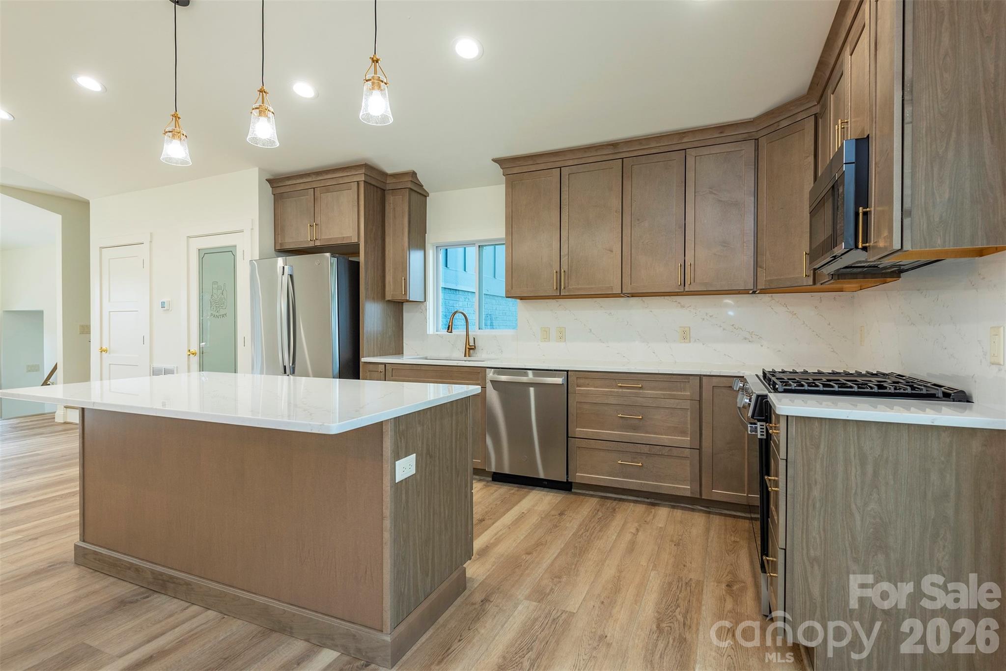 524 Pineland Road Hendersonville, NC 28792 - Photo 10 of 36 a kitchen with kitchen island a sink stainless steel appliances and cabinets