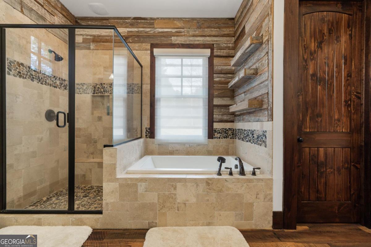 4096 Big Water E Road Sparta, GA 31087 - Photo 18 of 70 a bathroom with a bathtub and shower