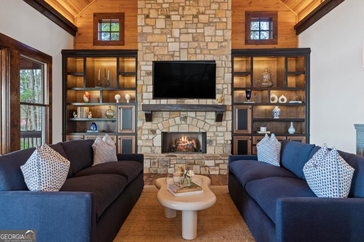 4096 Big Water E Road Sparta, GA 31087 - Photo 22 of 70 a living room with furniture a flat screen tv and a fireplace