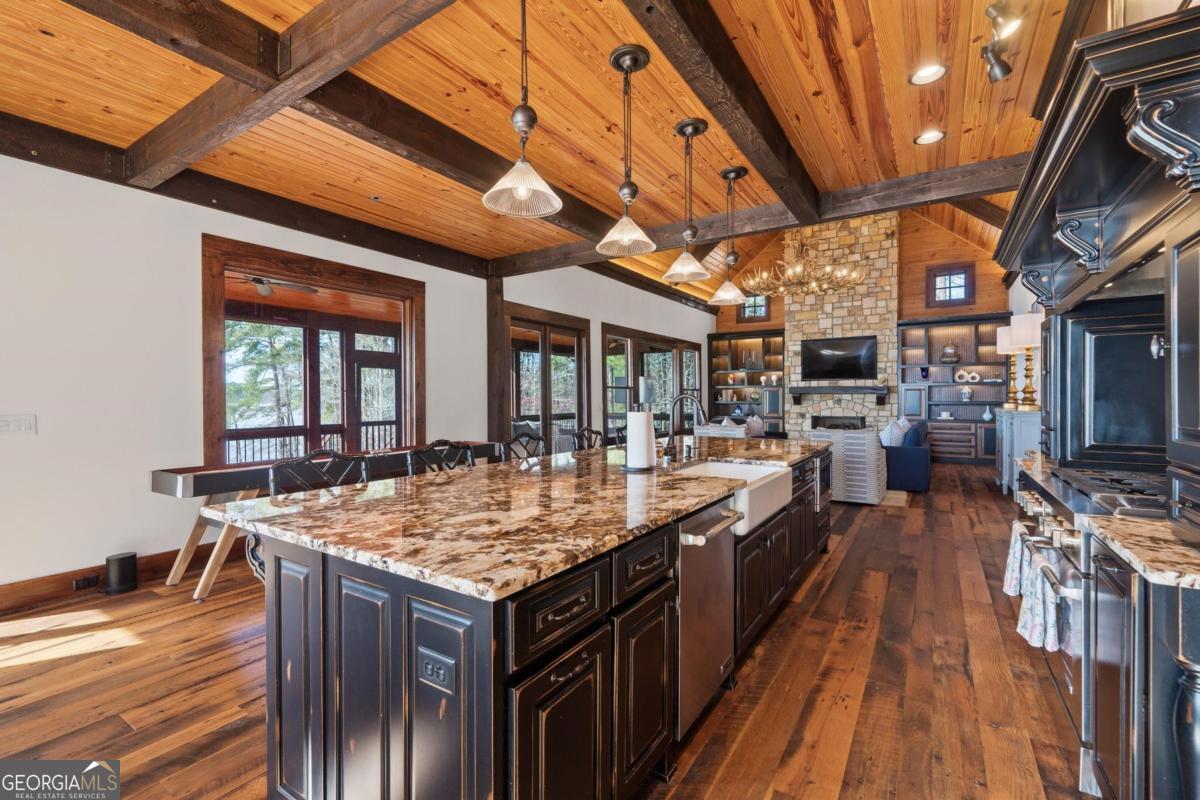 4096 Big Water E Road Sparta, GA 31087 - Photo 32 of 70 a kitchen with stainless steel appliances granite countertop a stove and cabinets