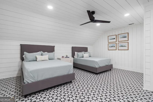 a view of a balcony with lake view and a couple of couches with wooden floor and fence