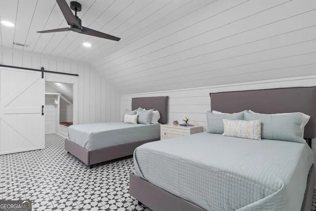 a balcony with wooden floor and outdoor seating